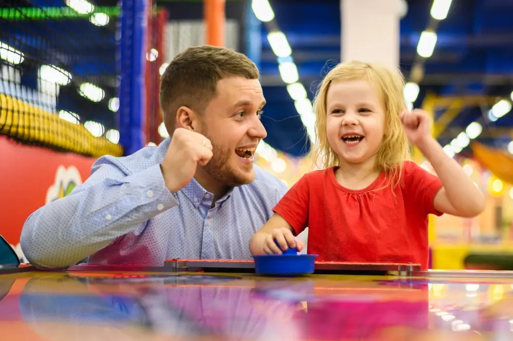 kid having fun with her dad